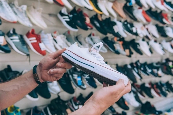 Man Holds Sports Sneakers His Hand Supermarket — Stock Photo, Image