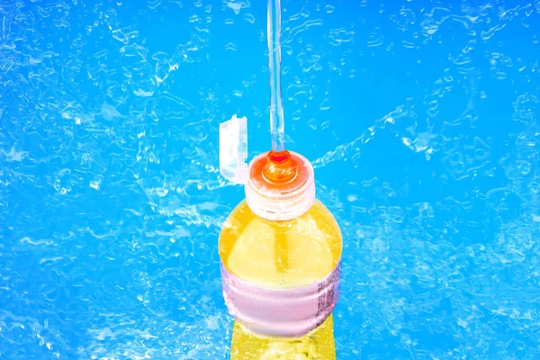 Sports drink bottle squirting and splashing liquid