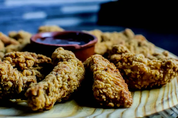 breaded chicken fingers with barbeque sauce in the center