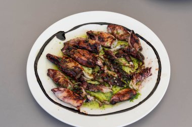 Bir tabak taze ızgara kalamar ve sos.