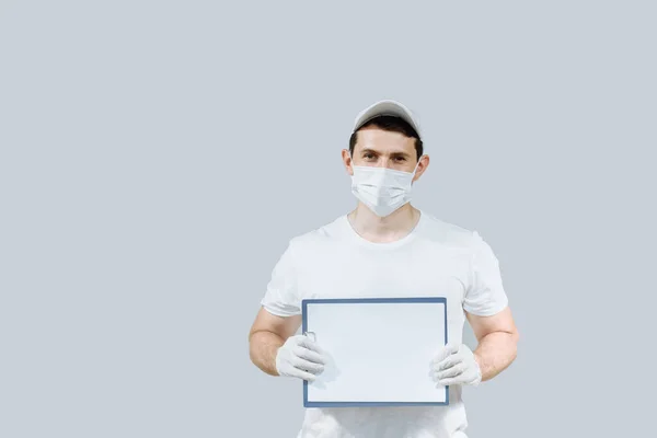 delivery man in white uniform gloves and mask on an isolated gray background with clipboard