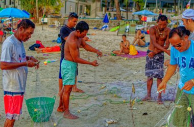 PHUKET, THAILAND, Ocak 03 2020: Yerel balıkçılar Tayland 'ın Phuket plajındaki ağdan balık avlıyorlar.