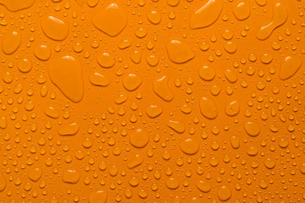Zbliżenie Wody Kropla Pomarańczowy Tło — Zdjęcie stockowe