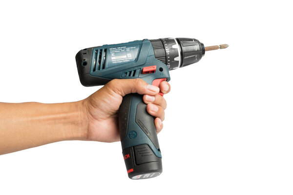 Ubon Ratchathani, Thailand -June 19,2019:Bosch power electric drill generation GSB 120 LI in isolated on white background, Close-up hand holding electric drill in isolated white background