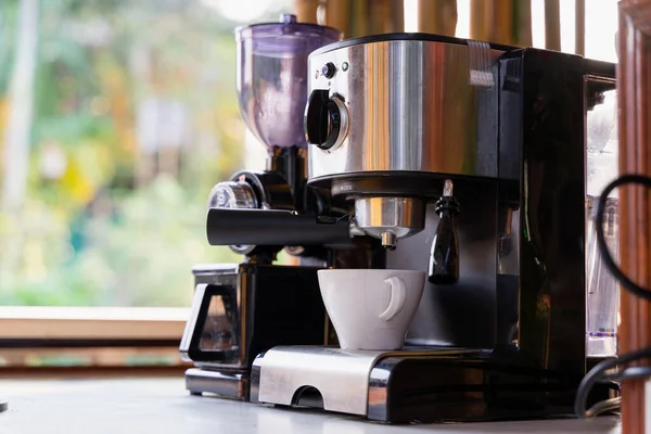 white coffee cup and coffee maker machine