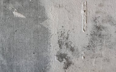 Sert, gri beton bir duvarın yüzeyi. Doku çimento duvarından arkaplan.