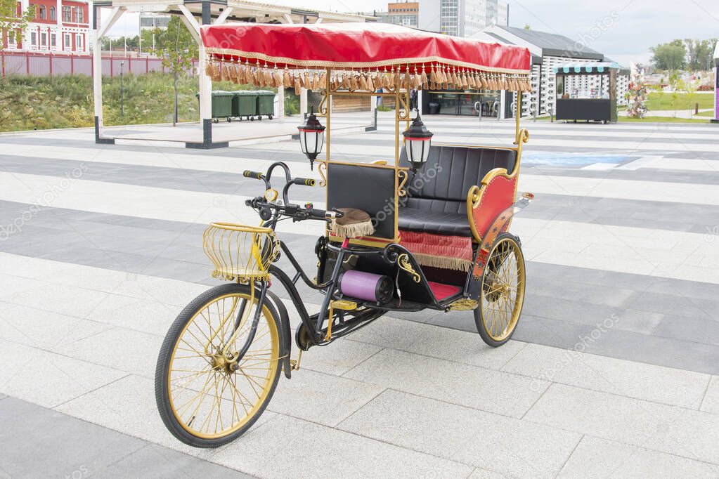 brightly decorated tricycle on a city street awaits tourists