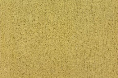 Gözenekli sarı kum arka planı soyutlamayı anımsatıyor. 