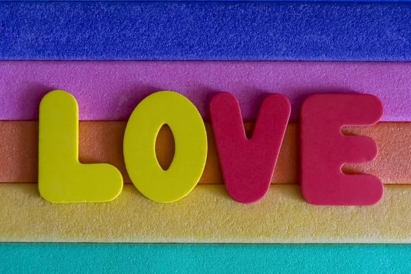 colored letters on an old multicolored porous surface