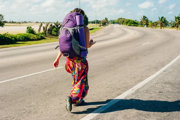 Cute American woman hitchhiking