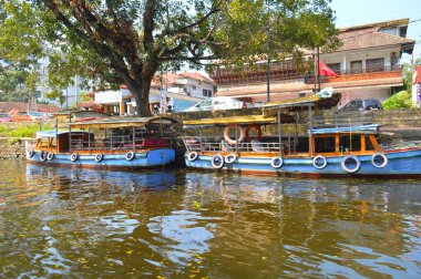 Alleppey Kanalları boyunca demirlemiş Shikara teknelerinin görüntüleri durgun turizmiyle ünlüdür.. 