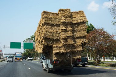 Şehirdeki yol, arabadaki saman balyaları. 
