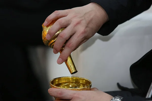 hand holding golden pray objects