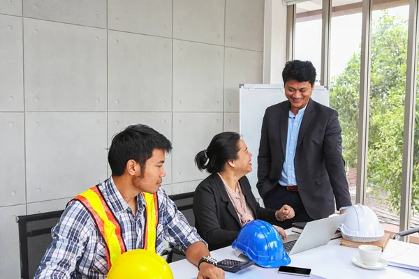 The manager is checking the work of the engineer team. Planning of engineers and technicians. Engineers and Architects Planning for a project. Asian people.