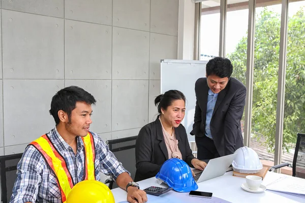 The manager is checking the work of the engineer team. Planning of engineers and technicians. Engineers and Architects Planning for a project. Asian people.