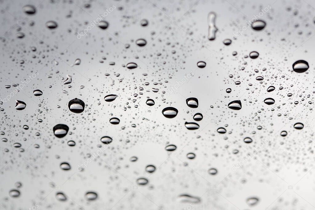 water drop. Water drops on glass surface as background. Drops of rain on glass. Sky background. Thailand.