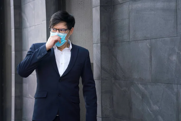 Social distance. Company employees wear a mask to work in the office. company employees wear protective masks to prevent PM 2.5 dust and virus COVID-19. Businessman air excessively smelling bad.