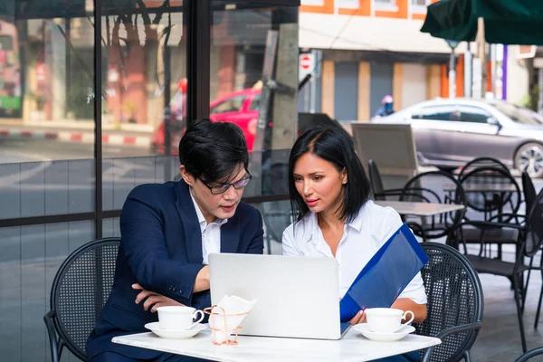 Co-working space concept. Businessman and Businesswoman is brainstroming in a co working space. Young business discussing in coffee shop.