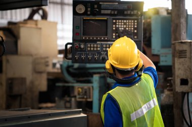 Fabrikadaki profesyonel mühendisler. Teknisyenler makinelerin endüstriyel santrallerdeki işleyişini kontrol ediyorlar..
