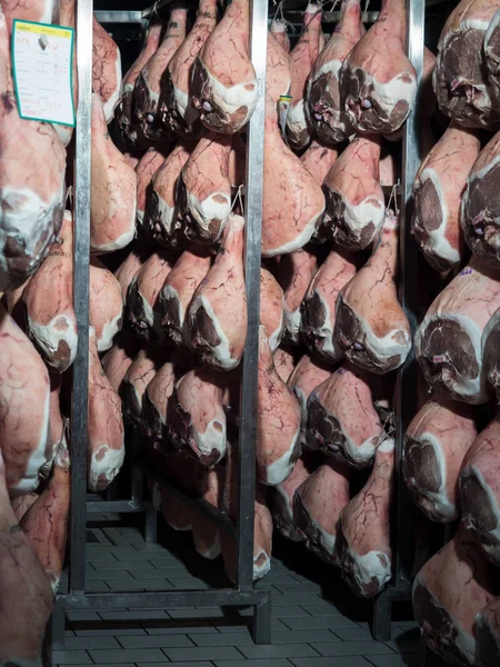 Thighs of ham during the drying process within a temperature and humidity controlled cell.