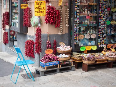 Tropea, Italy - August 21, 2018: Typical shops in Tropea where you can buy spicy Calabrian peppers and the famous Tropea onions. clipart