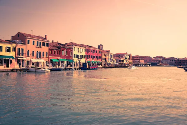 Historic buildings on the banks of the canal in Venice at sunset.