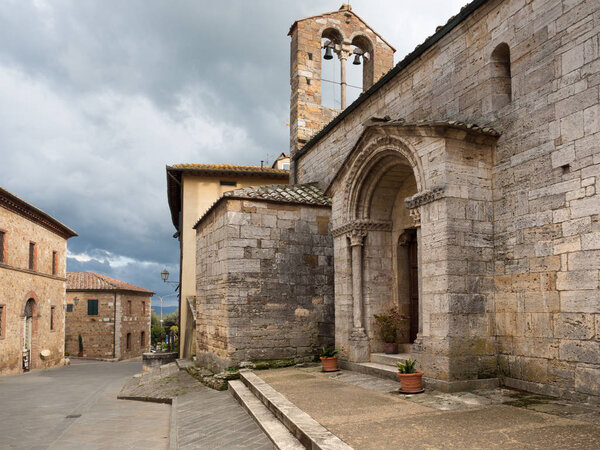 Ancient stone church in San Quirico D'Orcia, old medieval villag