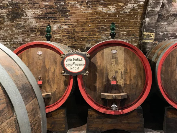 Oak barrels in an old underground wine cellar.