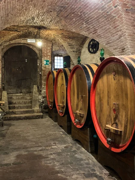 Oak barrels in an old underground wine cellar.