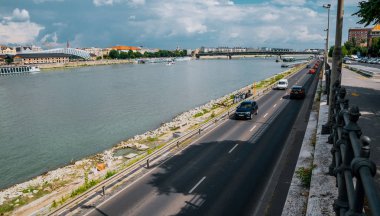 Budapeşte, Macaristan - 29 Ağustos 2019: Budapeşte, Macaristan'da rıhtımda eski evlerin otoyol ve cepheleri. Yoğun saatlerde Tuna Nehri boyunca bir şehir caddesi boyunca araba sürmek. Tarihi şehir merkezi ve ünlü turistik