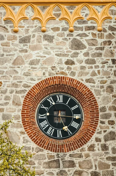 Old clock on the wall, Gothic clock tower in the square of the medieval city