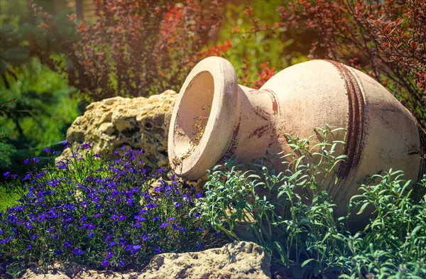 Decorations of an old garden on a sunny summer morning