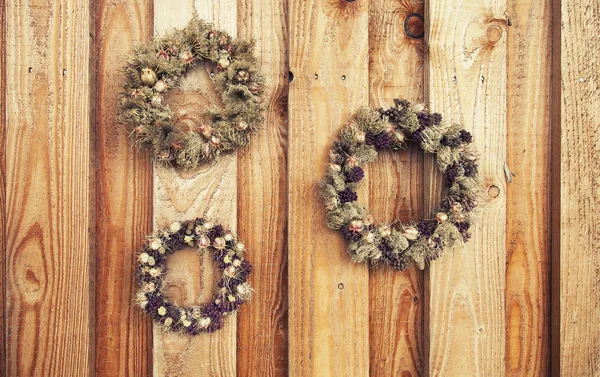 Blomsterkrans på trä rustik bakgrund — Stockfoto