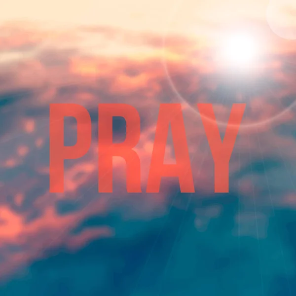 Het woord bidden op de achtergrond van de blured Red Sky — Stockfoto