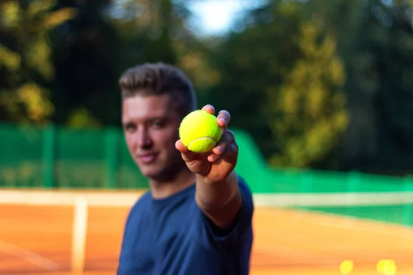 Man show tennis close-up ball
