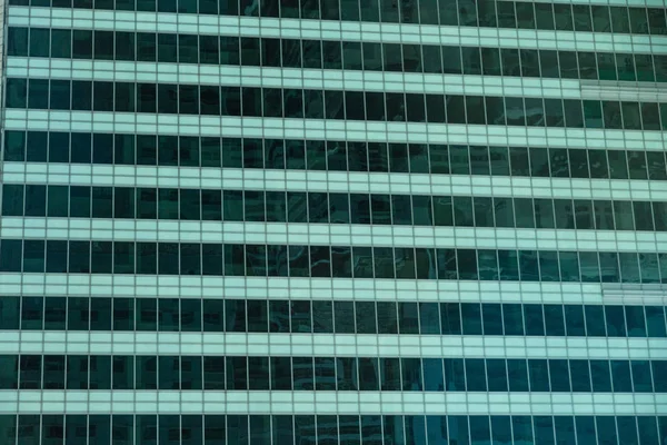 Wide angle abstract background view of steel light blue high rise commercial building skyscraper made of glass exterior. concept of successful modern industrial architecture and office center building — Stock Photo, Image