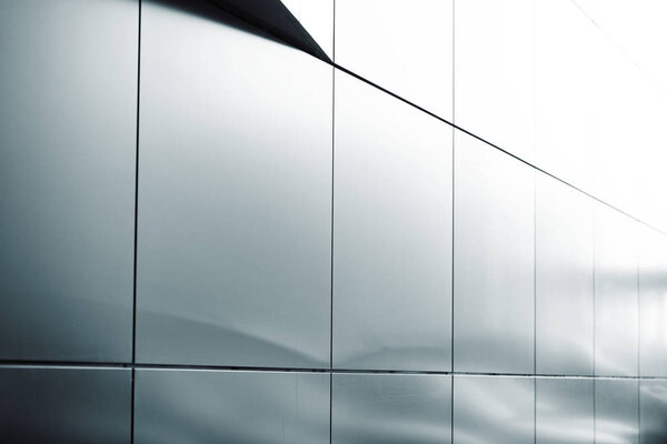 Wide angle abstract background view of steel light blue high rise commercial building skyscraper made of glass exterior. concept of successful industrial architecture and office center building