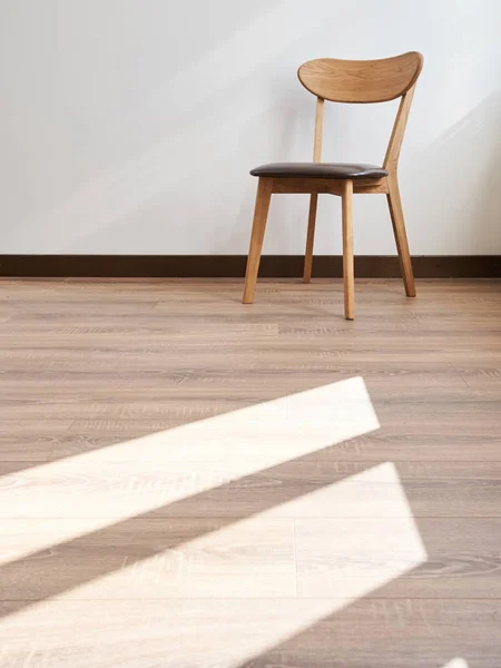 Wooden chair over white wall interior