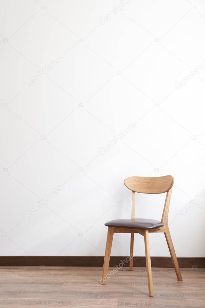 Wooden chair over white wall interior