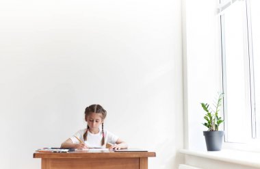Masada otururken çocuk kız çizim ve resimde evde