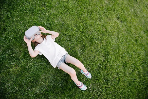 Kid girl using virtual reality glasses outside — Stock Photo, Image