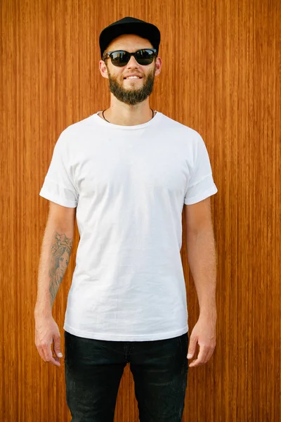흰색빈 티셔츠를 입은 덩치큰 남성 모델과 평범 한 도시 스타일의 로고나 디자인을 위한 공간이 있는 야구 모자를 착용 한 덩치큰 남성 모델 — 스톡 사진