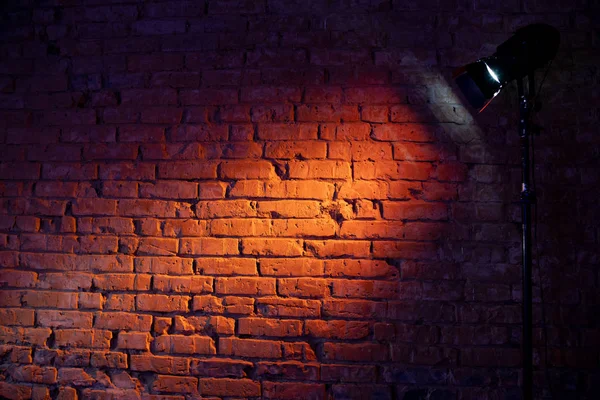 Brick wall lit up by lamp light