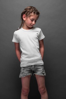 Logonuz için yer veya gri arka plan üzerinde tasarım ile beyaz t-shirt giyen çocuk kız
