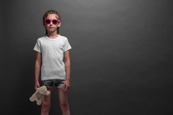 Kid girl wearing white t-shirt with space for your logo or design over gray background — Stock Photo, Image