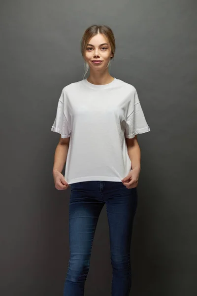 Sexy woman or girl wearing white blank t-shirt with space for your logo, mock up or design in casual urban style