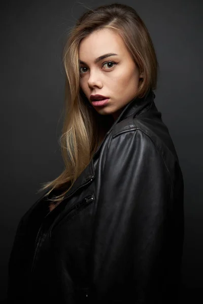 Fashion portrait of a sexy blonde woman with a make up wearing black clothes — Stock Photo, Image