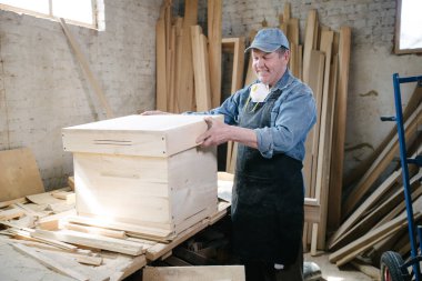 Carpenter man posing in carpentry workshop clipart