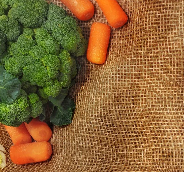 still life in the form of a frame of vegetables on a background of burlap