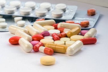 Tablet hastalıklarının tedavisi için bir sürü bir masada evde dağılmışlardır. Masadaki diğer ilaçlar. Vitaminler bir masada evde. Hastanın ısısını ölçmek için termometre